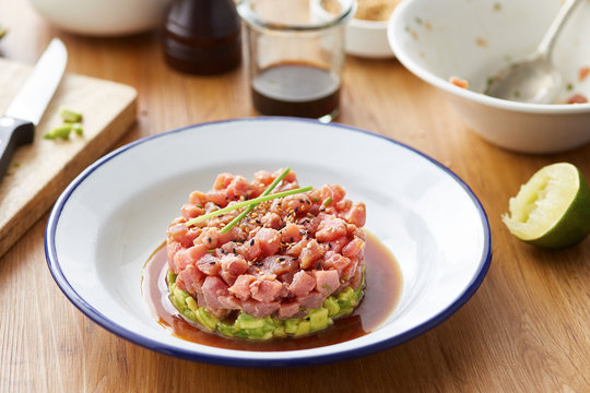 Served tartare on white plate with blue hem