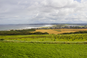 Fototapeta na wymiar A panoramic view Castlerock and Coleraine towns with the River Bann seen from the hilltop at the Downhill Demesne on the north coast of County Londonderry in Northern Ireland