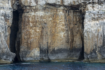 Rock massif with a cave in the Ionian Sea