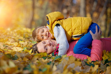 Happy beautiful mother with her little son in the park