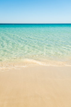 Fototapeta beautiful beach with golden sand and crystal clear aqua blue water