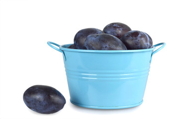 Plums in the bowl isolated on white background