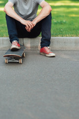 Unrecognizable hipster man with skateboard, extreme sport challenge and competition background with free space. Skateboarder modern urban lifestyle and culture, ready to adventure