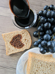 in a bowl,on a wooden floor hearted, molasses, a wooden spoon and bread slices on the side. healthy fruits. 