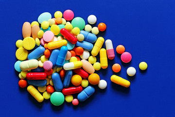 Colorful pills on a blue background