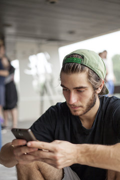 Young man typing on his phone
