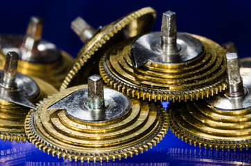 Watch Repair: Vintage Pocket Watch Fusee Cones Resting on a Blue Surface