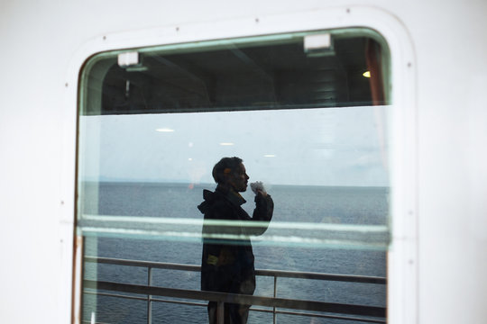 Man smoking cigarette on ferry boat