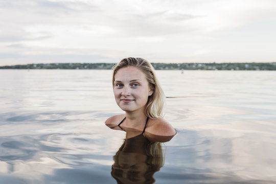 Pretty young woman in calm lake