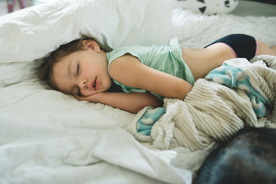 Toddler girl passed out in bed