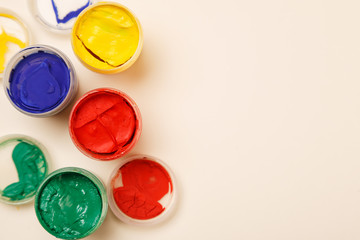 Open small paint jars on a table, selective focus, top view, copy space