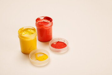 Open small paint jars on a table, selective focus