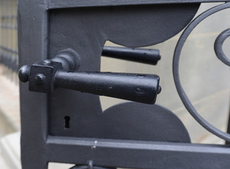 Black metal door handle on exterior metal door