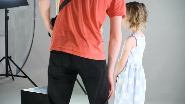 Little girl in the process of video clip shooting