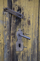 Vintage rusty  door handle on wooden door