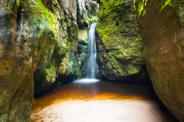 Fototapeta na wymiar Waterfall Maly Adrspassky vodopad in the rock mountain Adrspasske skaly in Czech republic