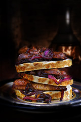 Sausage and fried onion open sandwich