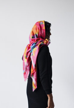 Silhouette of woman wearing a head scarf.