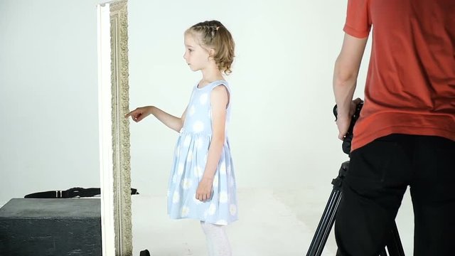 Little girl in the process of video clip shooting