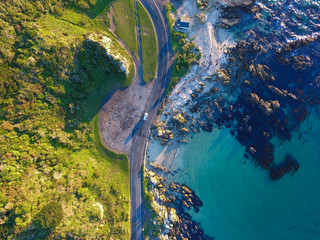 Looking down on winding coastal roads in New Zealand