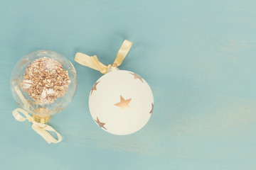 Blue and white christmas with two balls on blue wooden background, retro toned