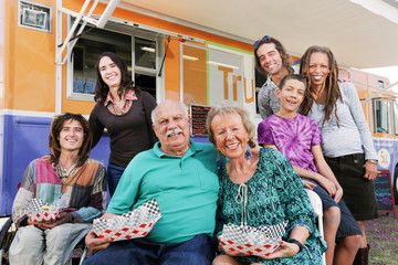 Elderly couple surrounded by diverse friends