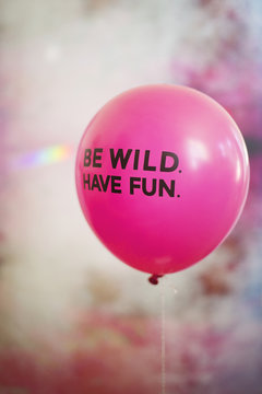 Words be wild, have fun on pink flying balloon