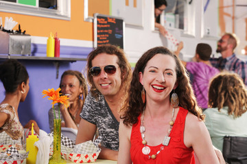 Smiling couple have date at food truck