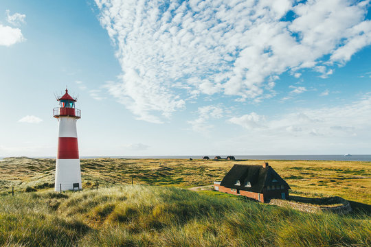 Lighthouse and Remote Homes on Sunny Summer Morning in Sylt (Germany)