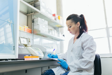 Young Scientist Woman Working in a Professional Laboratory