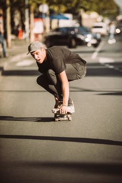 Skateboarder ride a skateboard slope through the city street