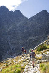 Fototapeta na wymiar Tourists hiking on a mountain trail
