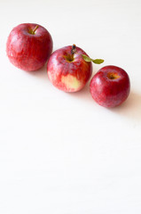three red apples on white background