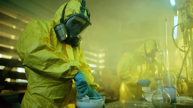 In the Underground Drug Laboratory Two Clandestine Chemists Cook Synthetic Drugs, Crush Them in a Bowl and Package for Further Distribution. 