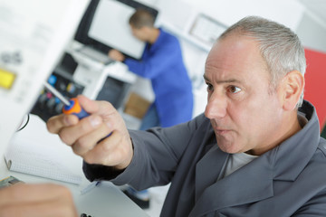 Fototapeta na wymiar young technician in lab coat repairing computer