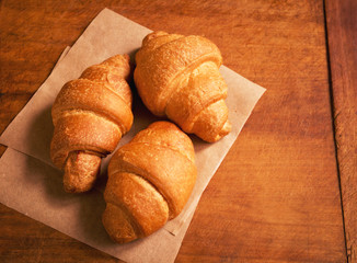 French breakfast with fresh croissants on wooden table