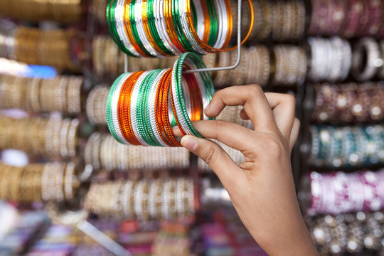 Teenage girl holding colorful bangles