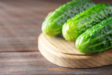 Fresh raw green cucumbers on a wooden table