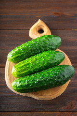 Fresh raw green cucumbers on a wooden table