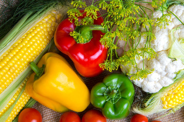 Fototapeta na wymiar vegetables, vegetables on the table. corn, cauliflower, tomatoes, champignons, chili peppers