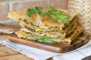 homemade pastries with cheese and greens