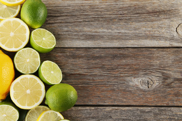 Ripe limes and lemons on wooden table