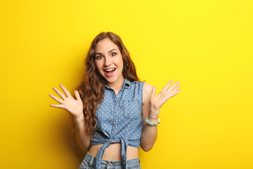 Portrait of young woman on yellow background