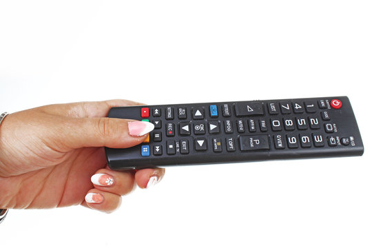 Woman hand holding remote control on isolated white cutout background. Studio photo with studio lighting easy to use for every concept.