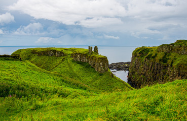 Ruins of Dunseverick Castle in Northern Ireland. Landscape of green cliffs on the emerald island.