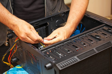 Computer technician installs system of computer. Assembling PC