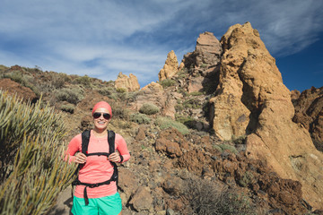 Naklejka premium Happy girl hiker walking on mountain path, backpacker adventure