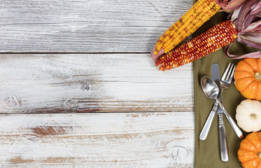 Thanksgiving dinner setting on rustic white table with colorful Autumn decorations