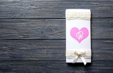 Lesbian wedding invitation on wooden background