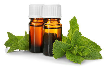 Bottles of essential oil with mint on white background